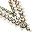 Kundan Majesty Double Layer Set. Gold and green double-layer Kundan necklace set with pearls, matching jhumka earrings, and maang tikka – perfect for festive and traditional wear.
