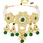 Floral Cascade Faux Kundan Set. Gold and green choker necklace set with Kundan, green beads, and white pearls, paired with matching earrings and maang tikka perfect for festive and ethnic wear.
