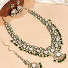 Nature's Glisten Green Necklace Set by Peora. Gold-plated green Kundan necklace set with matching earrings and maang tikka, featuring green beads & white pearls.