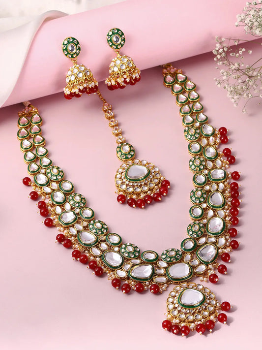 Nature's Glisten Green Necklace Set by Peora. Gold-plated red & Green Kundan necklace set with matching earrings and maang tikka, featuring red beads & white pearls.
