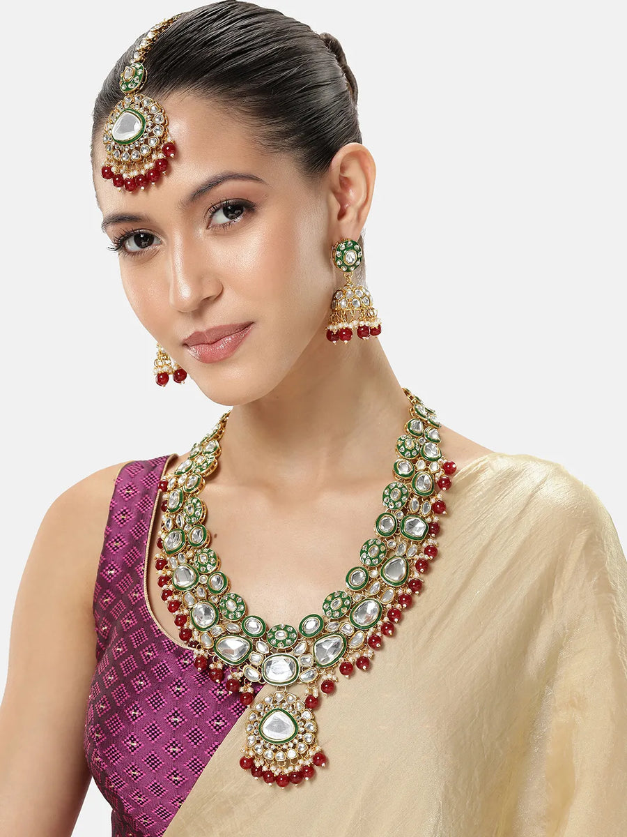 Nature's Glisten Green Necklace Set by Peora. Gold-plated red & Green Kundan necklace set with matching earrings and maang tikka, featuring red beads & white pearls.