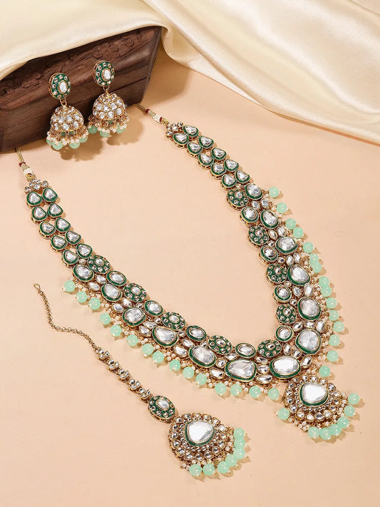 Glistening Nature Necklace Set by Peora. Gold-plated green Kundan necklace set with matching earrings and maang tikka, featuring mint green beads.