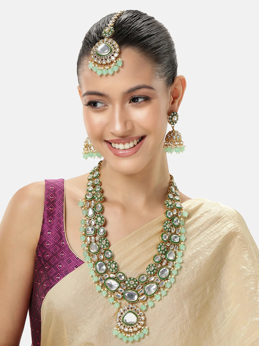 Glistening Nature Necklace Set by Peora. Gold-plated green Kundan necklace set with matching earrings and maang tikka, featuring mint green beads.
