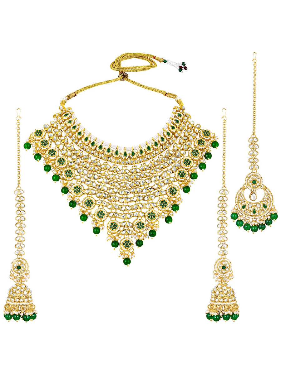 Royal Beads & Kundan Bridal Set. Gold jewellery set, pair of earrings & maangtikka embellished with with Kundan, green stones along with pearls. Prefect for your wedding day by peora.