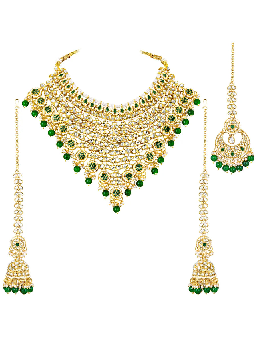 Royal Beads & Kundan Bridal Set. Gold jewellery set, pair of earrings & maangtikka embellished with with Kundan, green stones along with pearls. Prefect for your wedding day by peora.