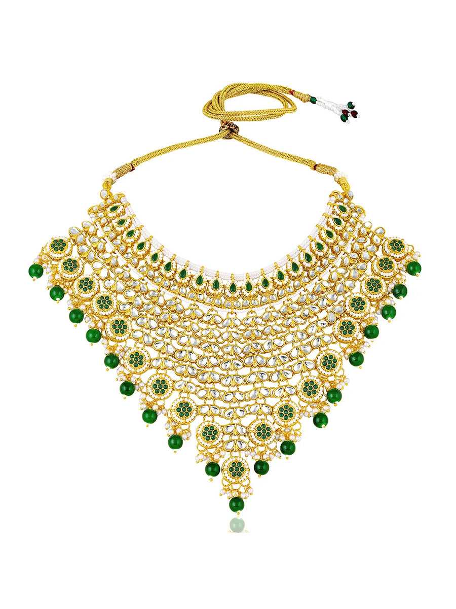 Royal Beads & Kundan Bridal Set. Gold jewellery set, pair of earrings & maangtikka embellished with with Kundan, green stones along with pearls. Prefect for your wedding day by peora.