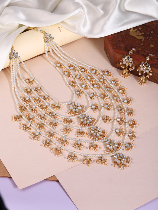 Kundan Cascade in Pearled Glory. Delicate necklace with floral designs. Best for a royal & regal looks. Make your occasion & wedding special with Peora.