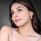 Luxurious Elegance CZ Jhumki Earrings. A pair of rose gold-colored CZ jhumki earrings with intricate designs and teardrop-shaped stones.
