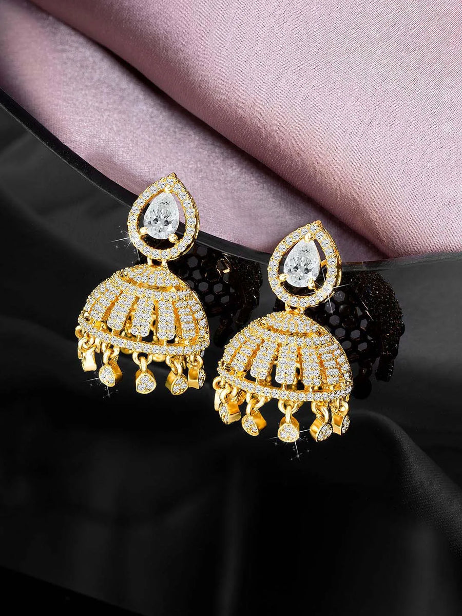 Luxurious Elegance CZ Jhumki Earrings. A pair of gold-colored CZ jhumki earrings with intricate designs and teardrop-shaped stones.