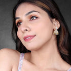 Luxurious Elegance CZ Jhumki Earrings. A pair of gold-colored CZ jhumki earrings with intricate designs and teardrop-shaped stones.