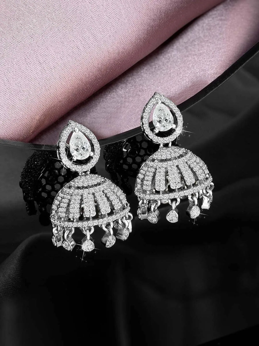 Luxurious Elegance CZ Jhumki Earrings. A pair of silver-colored CZ jhumki earrings with intricate designs and teardrop-shaped stones.