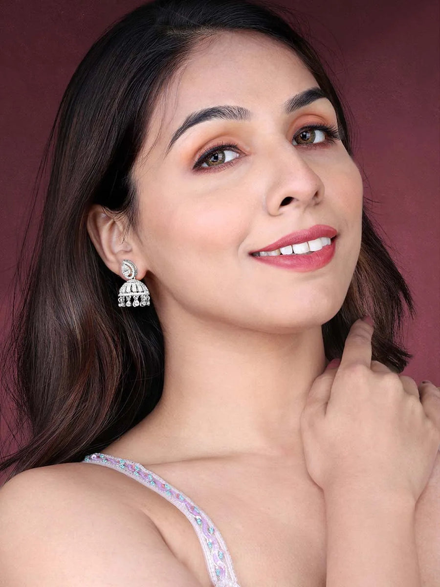 Luxurious Elegance CZ Jhumki Earrings. A pair of silver-colored CZ jhumki earrings with intricate designs and teardrop-shaped stones.