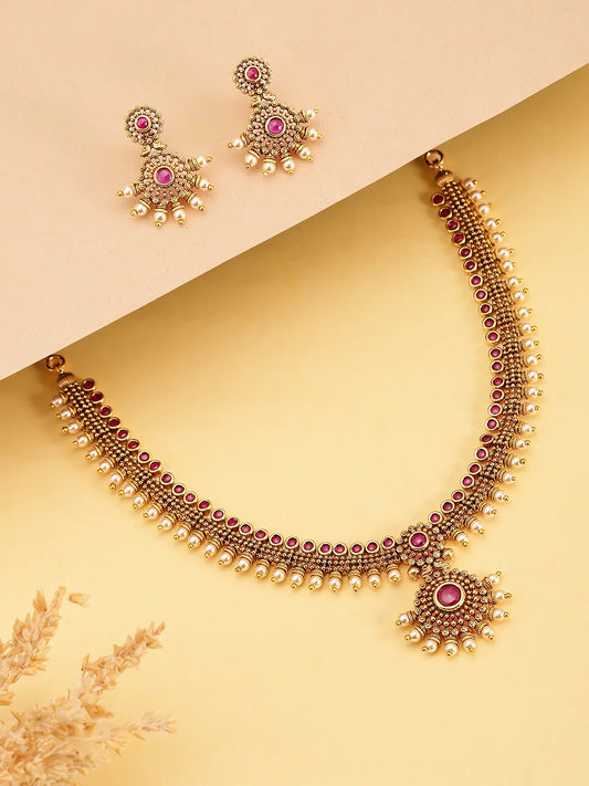 Elegant Faux Ruby Beaded Necklace Set. Gold necklace with pink stones and matching earrings. Best for ethnic, festive wear & special occasion. 