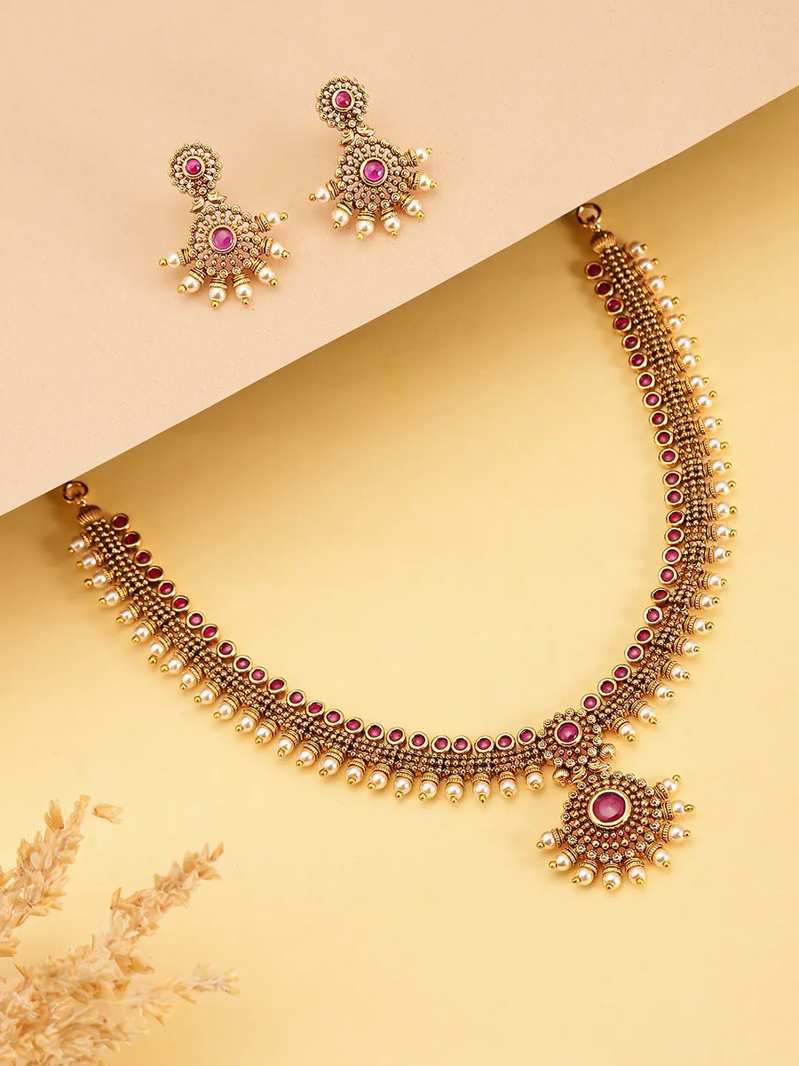 Elegant Faux Ruby Beaded Necklace Set. Gold necklace with pink stones and matching earrings. Best for ethnic, festive wear & special occasion. 