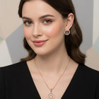 Elegant CZ Round Pendant Orbit Set. Rose gold-plated pendant necklace and a pair of earrings with a round pendant & CZ stones.