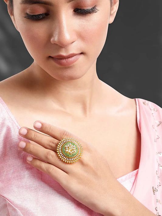 Bold and Glam CZ Statement Ring. Gold-plated adjustable ring with green and white cubic zirconia stones set in a floral pattern.
