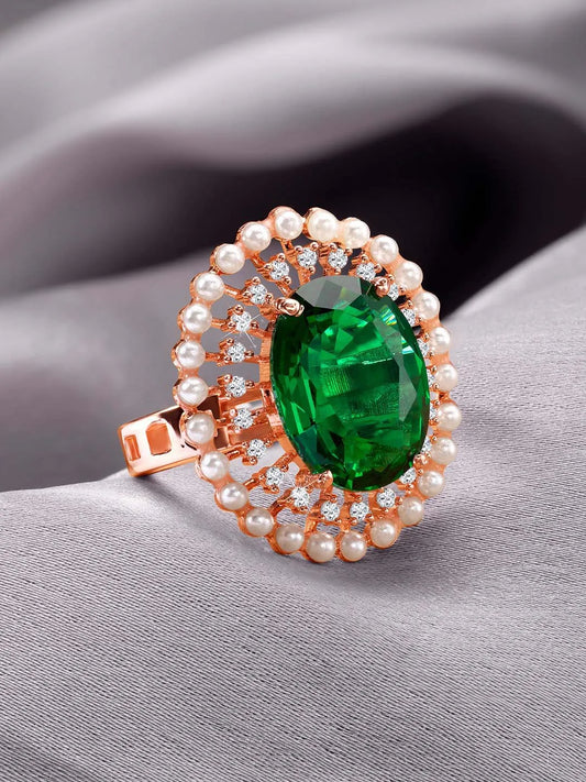 Opulent Green CZ Statement Ring by Peora. Adjustable ring with a rose gold-plating band and smaller white stones, pearls around the green centrepiece.