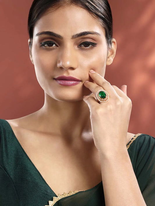 Opulent Green CZ Statement Ring by Peora. Adjustable ring with a rose gold-plating band and smaller white stones, pearls around the green centrepiece.