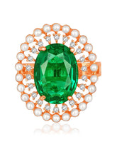 Opulent Green CZ Statement Ring by Peora. Adjustable ring with a rose gold-plating band and smaller white stones, pearls around the green centrepiece.