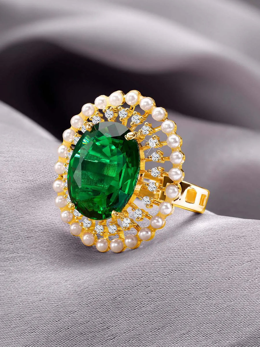Opulent Green CZ Statement Ring by Peora. Adjustable ring with a gold-plating band and smaller white stones, pearls around the green centrepiece.
