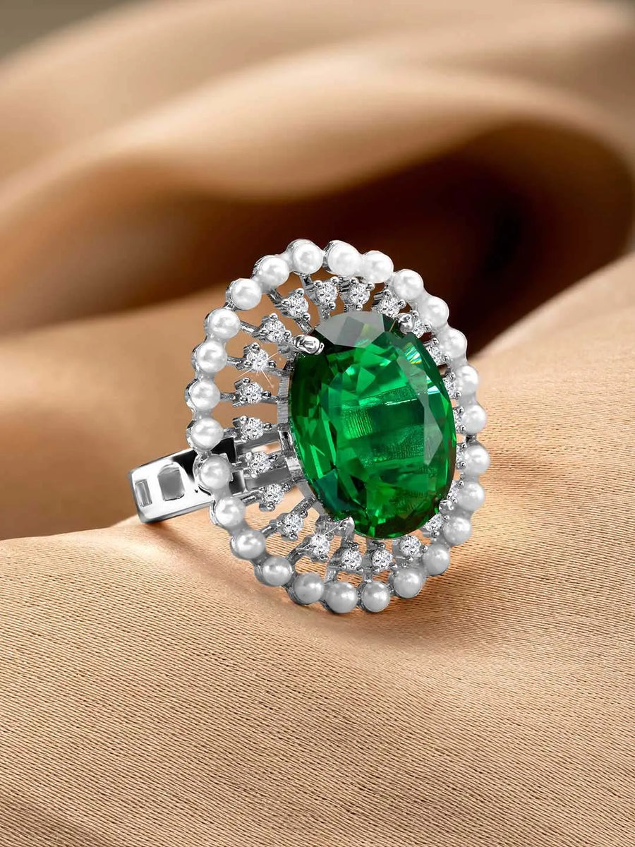 Opulent Green CZ Statement Ring by Peora. Adjustable ring with a silver-plating band and smaller white stones, pearls around the green centrepiece.