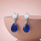 Peora Rhodium Plated Pear Blue Stone Earrings
