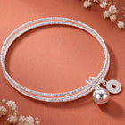 Rhodium Plated Coin Bell Charm Bracelet