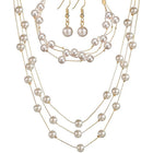 Timeless Glow Pearl Necklace Set featuring white pearls with gold-plated chain, matching bracelet, and earrings