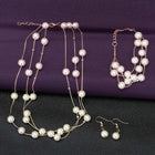 Timeless Glow Pearl Necklace Set featuring white pearls with gold-plated chain, matching bracelet, and earrings