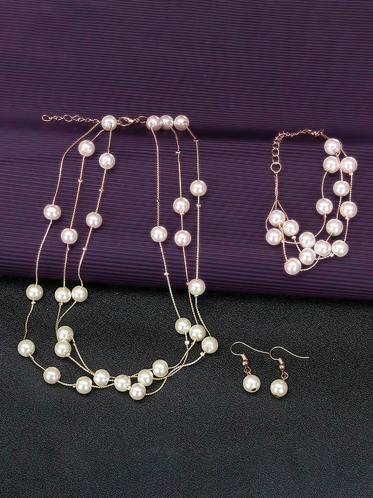 Timeless Glow Pearl Necklace Set featuring white pearls with gold-plated chain, matching bracelet, and earrings