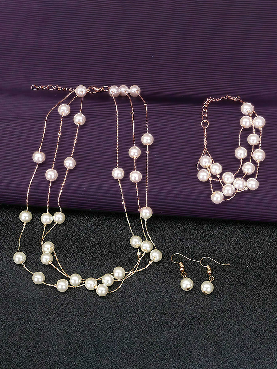 Timeless Glow Pearl Necklace Set featuring white pearls with gold-plated chain, matching bracelet, and earrings
