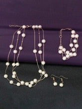 Timeless Glow Pearl Necklace Set featuring white pearls with gold-plated chain, matching bracelet, and earrings