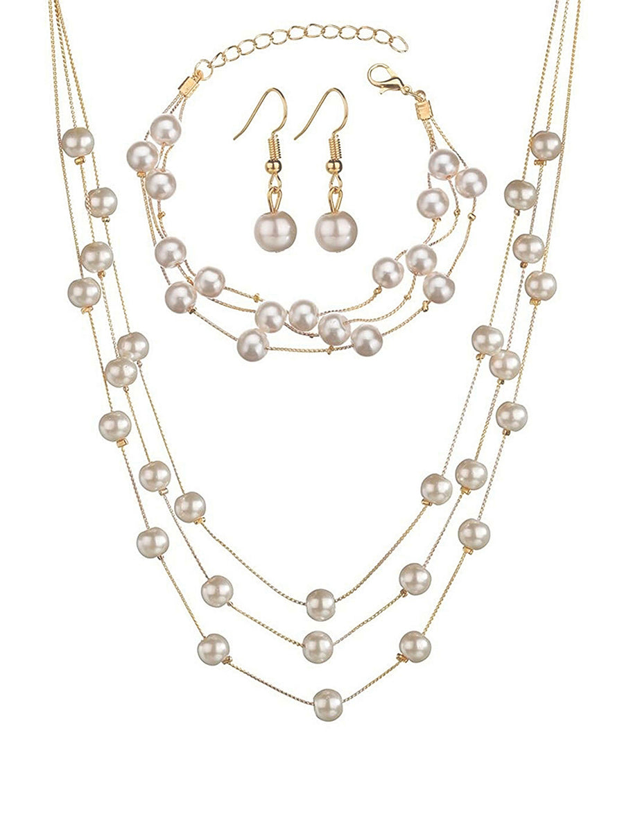 Timeless Glow Pearl Necklace Set featuring white pearls with gold-plated chain, matching bracelet, and earrings