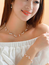 Timeless Glow Pearl Necklace Set featuring white pearls with gold-plated chain, matching bracelet, and earrings