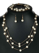 Timeless Glow Pearl Necklace Set featuring white pearls with gold-plated chain, matching bracelet, and earrings