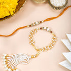 Close-up of Pearls & Beads Rakhi with Chain Tassel featuring mustard yellow & white thread, pearl & beads work, and gold plating – ideal for Raksha Bandhan | Peora
