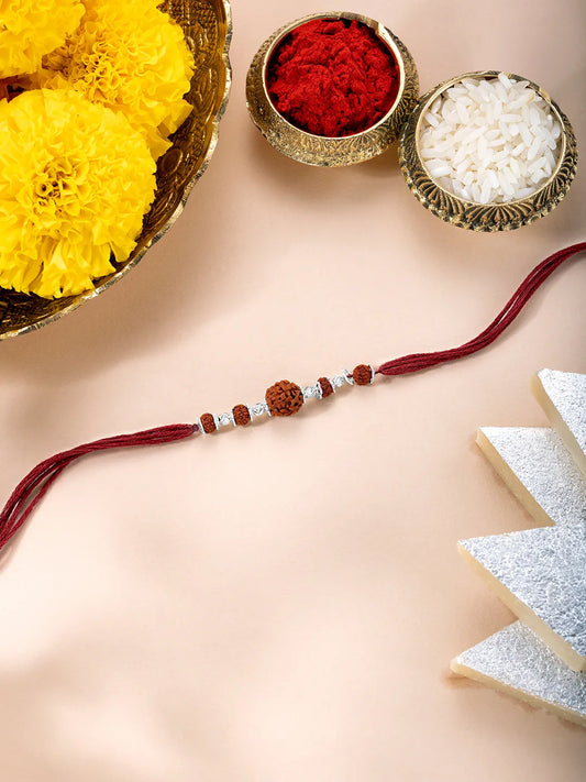 Close-up of Silver Rakhi Adorned with Rudraksh featuring maroon thread, nan work, and rhodium plating – ideal for Raksha Bandhan | Peora
