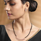 Stunning Radiant CZ Mangalsutra Set. Rose gold CZ mangalsutra set with black beads and matching earrings, in teardrop shape.