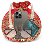 Red potli bag named Drawstring Potli with Zari Embroidery, featuring faux pearl detailing and soft fabric texture | Peora
