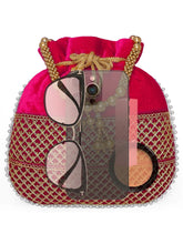 Red potli bag named Pearl Trim Zari Bead Potli Bag, featuring artificial beads detailing and soft fabric texture | Peora
