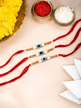 Close-up of Graceful Evil Eye Set of 3 Rakhis featuring red - blue thread, beads work, and gold plating – ideal for Raksha Bandhan | Peora
