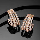 Glamorous Radiant CZ Half Hoop Earrings. A pair of rose gold-colored half hoop earrings with cubic zirconia embellishments. Ideal for casuals & party looks.