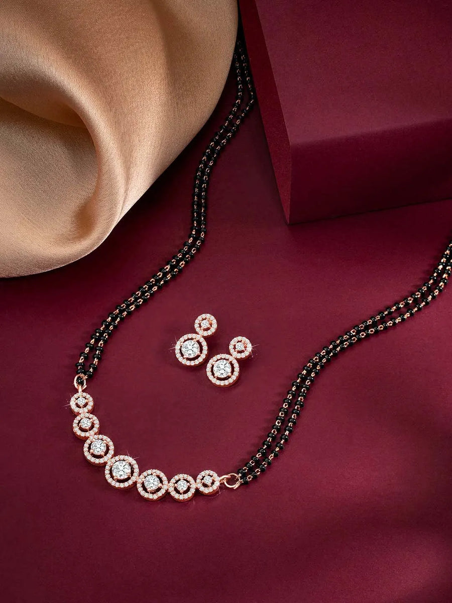 Luxurious Gleaming CZ Mangalsutra Set. Mangalsutra and matching earrings with cubic zirconia stones along with rose gold plating.