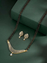 CZ Studded Traditional Mangalsutra Set. A traditional mangalsutra set with black beads and gold-color plating, zirconia stones, & matching earrings.