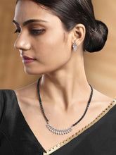 Stunning Radiant CZ Mangalsutra Set. Silver CZ mangalsutra set with black beads and matching earrings, in teardrop shape.
