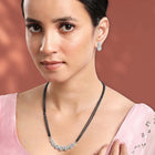 Luxurious Gleaming CZ Mangalsutra Set. Mangalsutra and matching earrings with cubic zirconia stones along with silver plating.