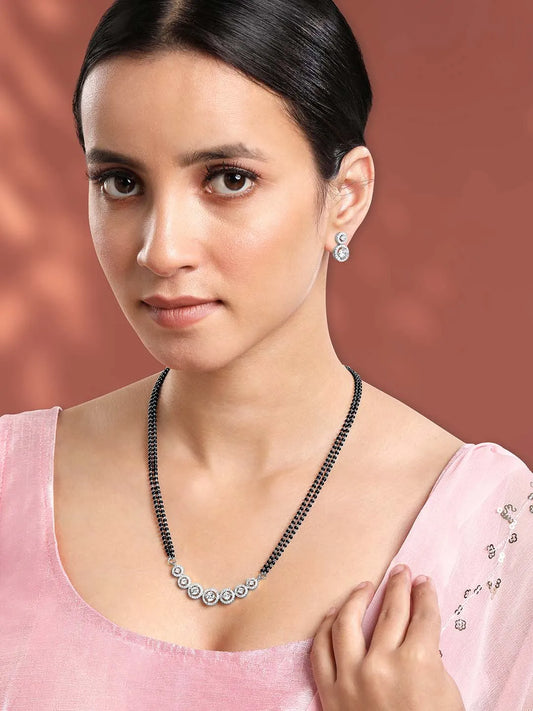 Luxurious Gleaming CZ Mangalsutra Set. Mangalsutra and matching earrings with cubic zirconia stones along with silver plating.