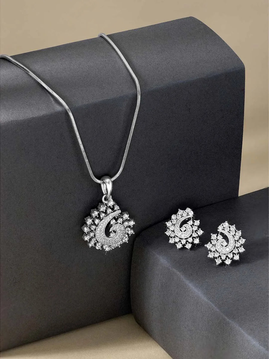 A set of silver jewellery including a paisley-shaped pendant necklace and matching earrings, both adorned with cubic zirconia.