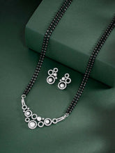 Beautiful Shimmering CZ Mangalsutra Set. A set of black beaded Mangalsutra with silver-colour and geometric patterns, with pearls, CZ stones.