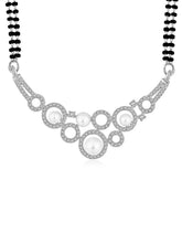 Beautiful Shimmering CZ Mangalsutra Set. A set of black beaded Mangalsutra with silver-colour and geometric patterns, with pearls, CZ stones.